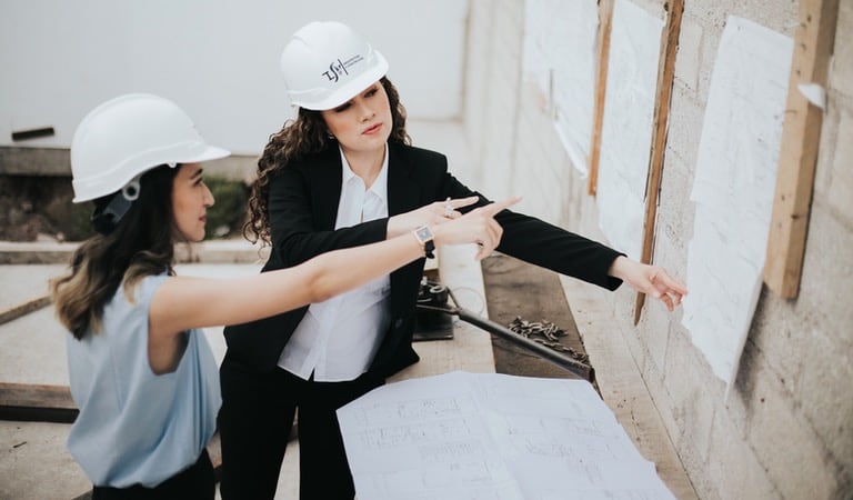 two women checking building regulations
