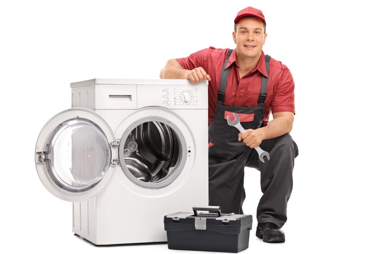 Repair man fixing a broken washing machine